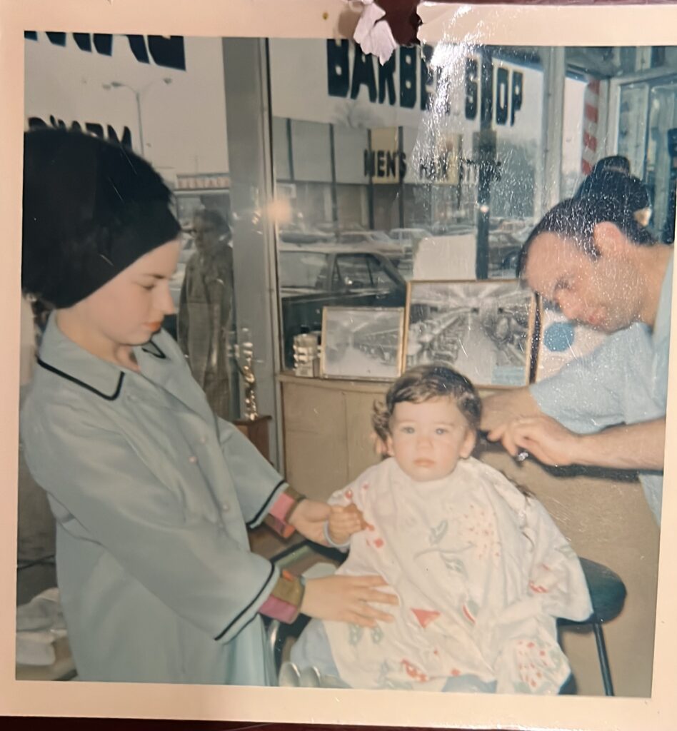 Young Moshe Milevsky gets a haircut at a barbershop